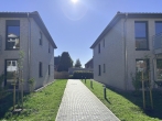 Durchgang zwischen den Häusern - Ihr neues Zuhause: Neubauwohnung mit modernstem Komfort und hochwertiger Ausstattung